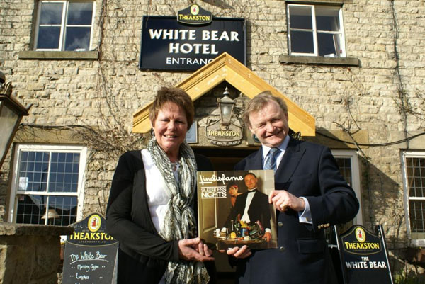 T&R Theakston Ltd Executive Director Simon Theakston and White Bear Hotel General Manager Sue Thomas hold the 1982 Lindisfarne album, Sleepless Nights, which features two Theakston’s beer bottles