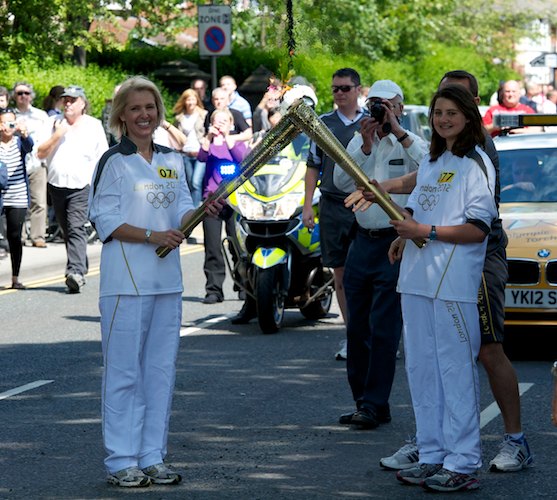 Kathryn Pridmore hands the flame to Megan Smith