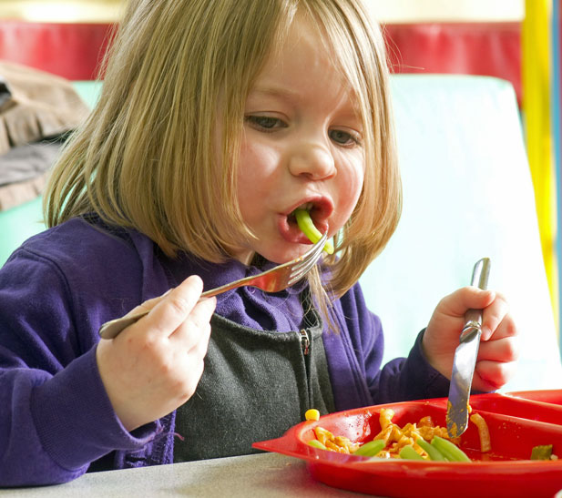A child from Reeth primary school enjoys a healthy school lunch