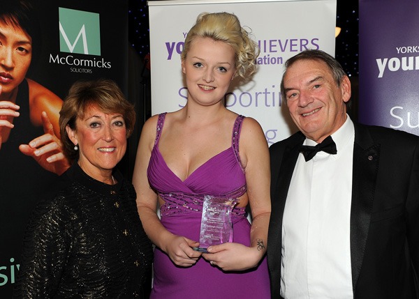 Ashleigh Young receives the Achievement in Management and Enterprise Award from Janine and Phillip Murphy