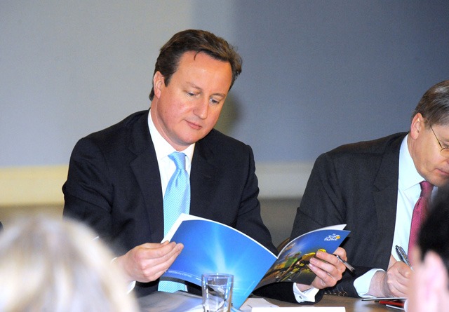 Prime Minister David Cameron looks through Welcome to Yorkshire's Tour de France brochure