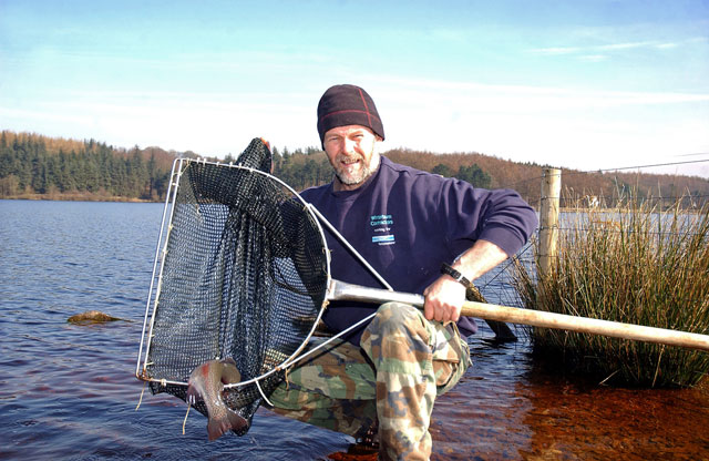 Colin Winterburn, fishery warden, shows off one of the latest recruits to Swinsty's waters
