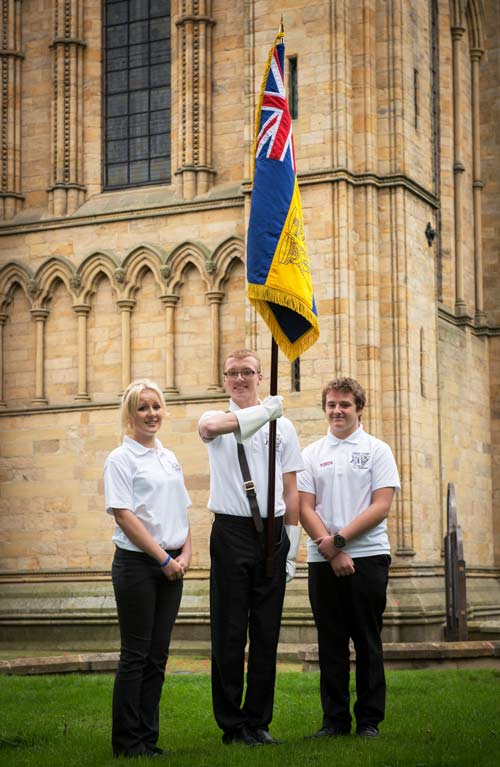 (left to right) Frankie Fitzwater, St Francis Xavier, Richmond; Jordan Radford, Outwood Academy, Ripon and Lewis Maclean, Bedale High School hold the North Yorkshire HMS Heroes standard outside Ripon Cathdral