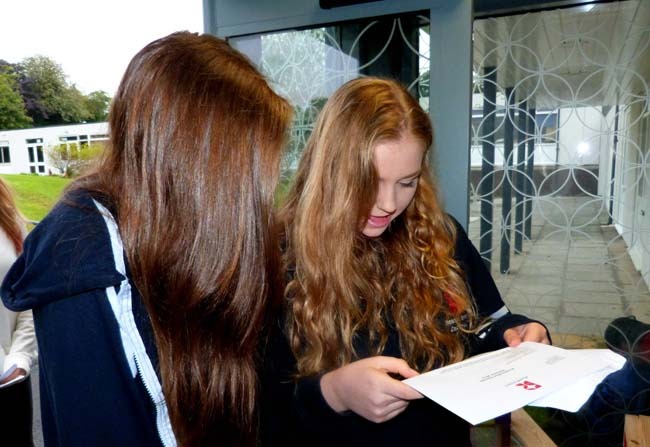 Helen Bairstow watches as Shona Harwell opens her GCSE results: 1A*, 6As and 1B