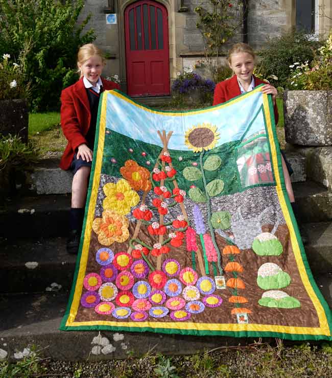 Milly Nattress (left) and Jessica Jones (right) with the ‘In The Garden’ quilt