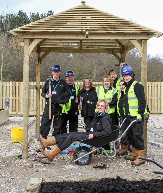 Volunteers from Cargill help to shape edible sensory garden at Henshaws Specialist College. Team from left to right: Norman Downey, Ben Rogers, Dionne Torkington-Craven, Anita Szarek, Jill Brown, Erik Vaan Straaten, Emma Proudley & Glen Mcgoldrick. (Not pictured but also taking part were Martin Douglas OBE, Cargill Managing Director, and Adam Blackburn who assisted in the project management