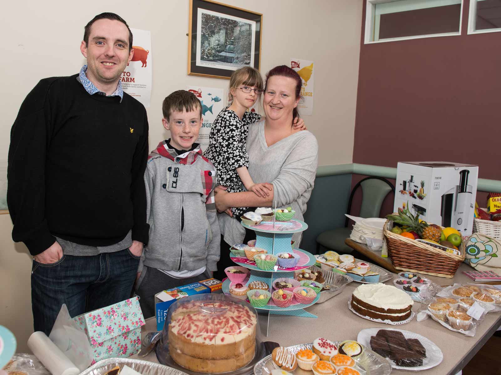 Oliva, (centre right) with her family at the cake and bake sale