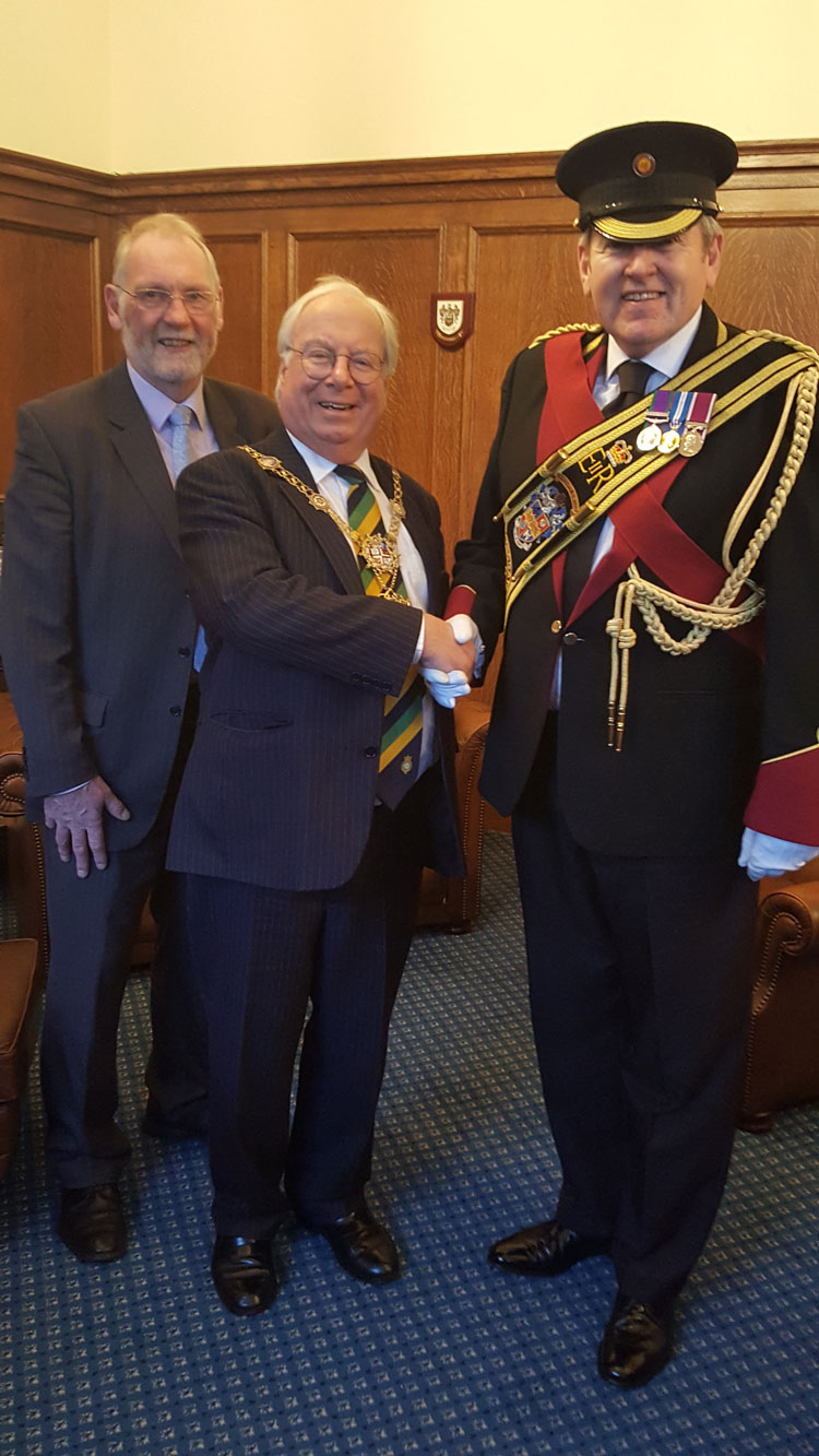Former Mayor of the Borough of Harrogate Councillor Nigel Simms and Councillor Nick Brown - Mayor of the Borough of Harrogate present the sash to Gareth Gibbs, Vice President and Drum Major of the Harrogate Band.