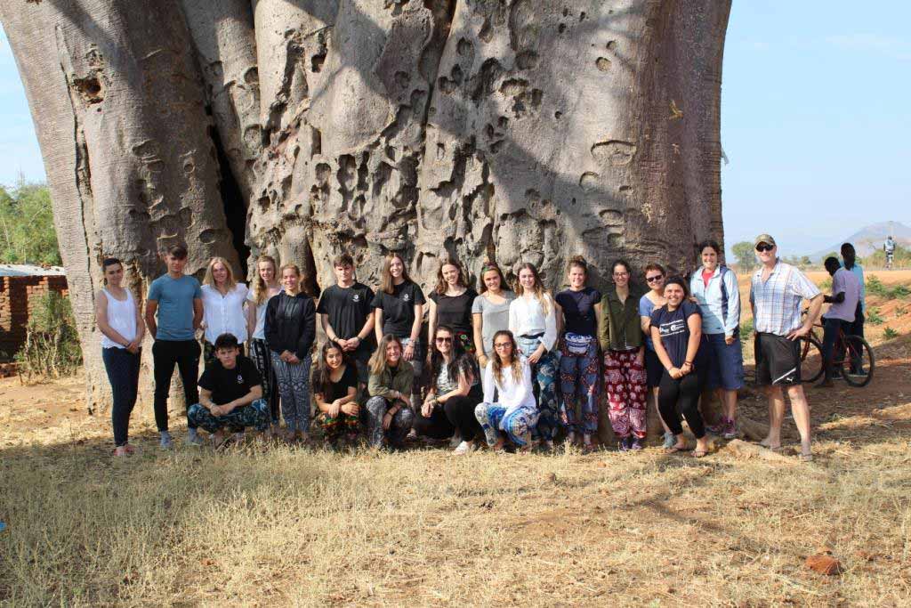 Group photo in front of a baobab tree in Nkhotakota, Malawi