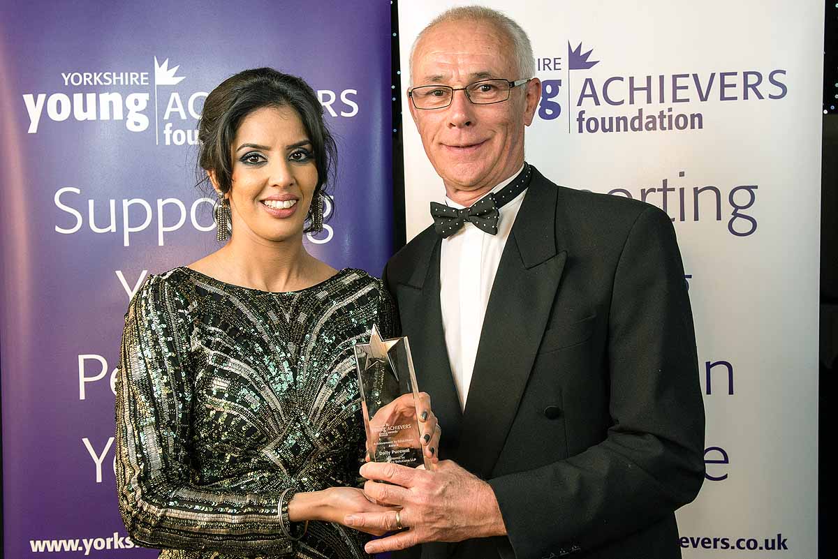 Dally Purewal receives the Achievement in Education Award from Stephen Burwood of Wetherby-based sponsors Positive Tax Solutions