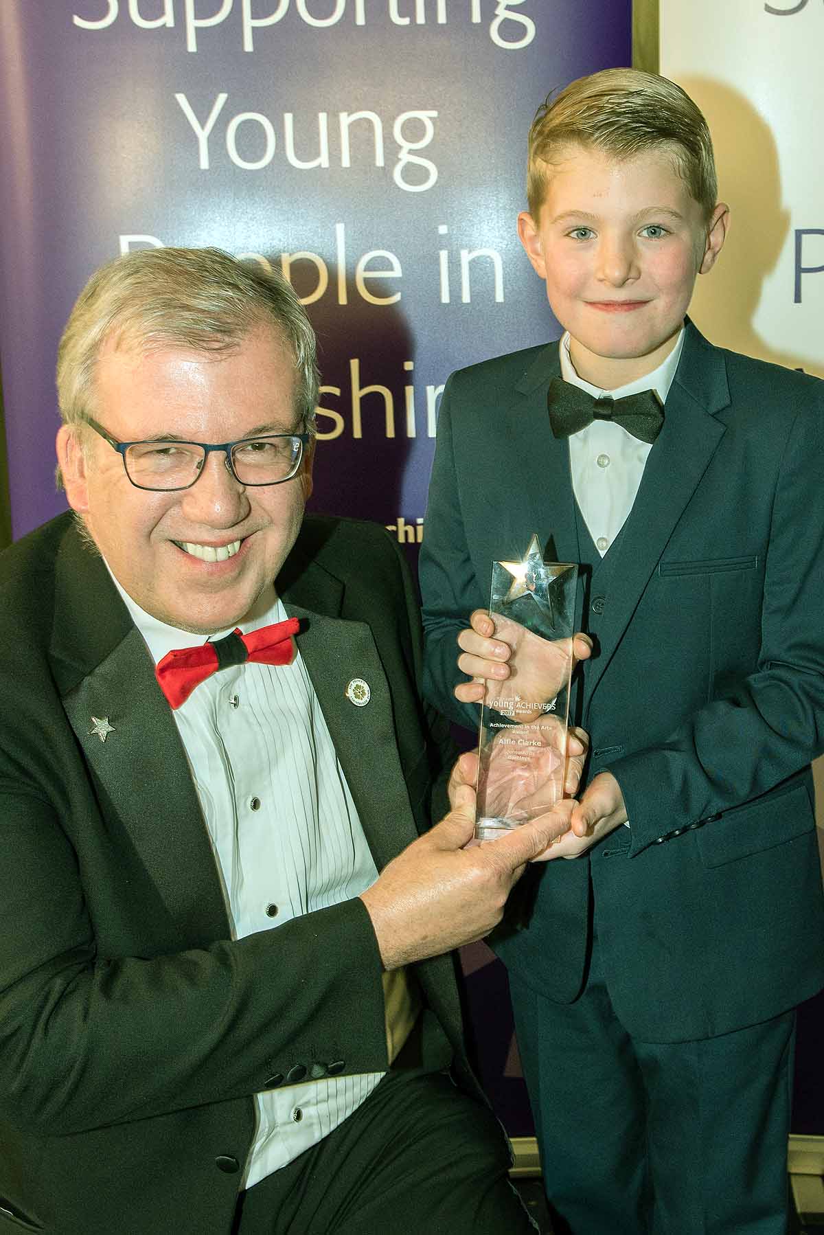 Achievement in the Arts winner Alfie Clarke receives his Award from Martin Gerrard of sponsors Barclays