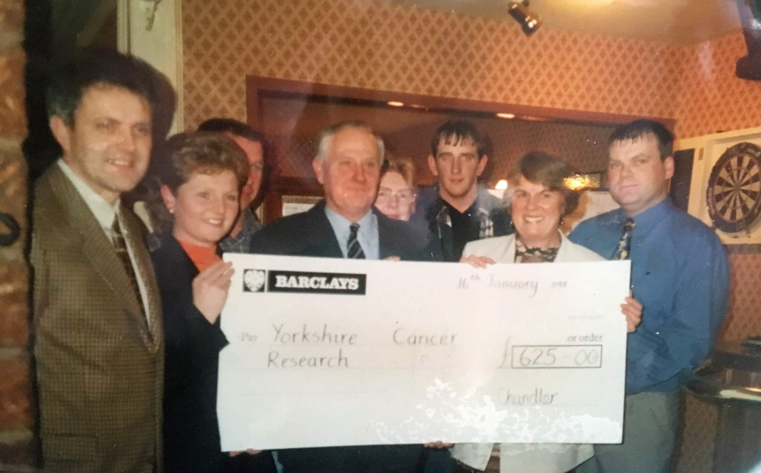 Michelle, second from left, and her father, centre, present a cheque to Jenny Moss, second from right, following Michelle’s first party in 1998