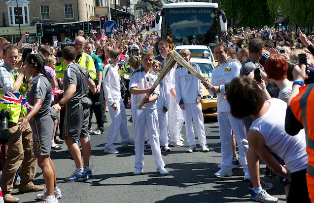 Holly Whyte and team hand over the flame to Stewart Owen