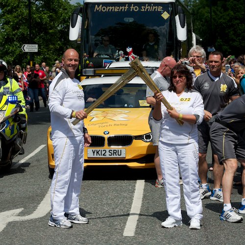 Andrew Mcmenemy hands flame over to Carol Newman