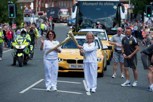 Judith Charlesworth takes the flame from Carol Newman