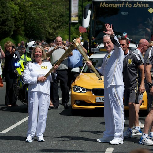 Judith Charlesworth hands the flame to Hugh O`Neill 