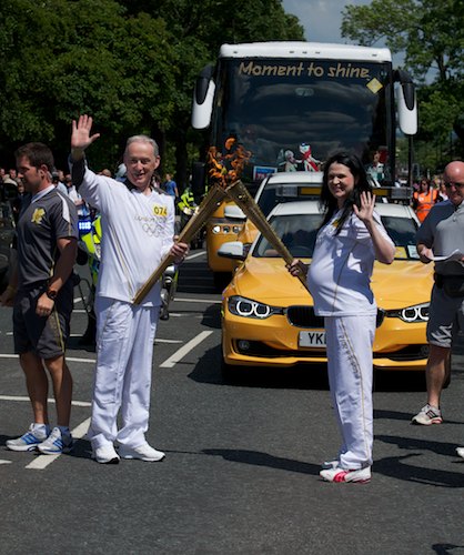 Hugh O`Neill gives the flame to Anita Adams and baby to be