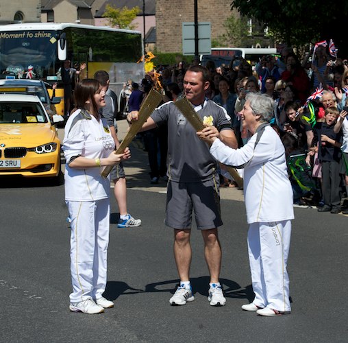 Caitlin Chang gives the flame to Hanneke Dye