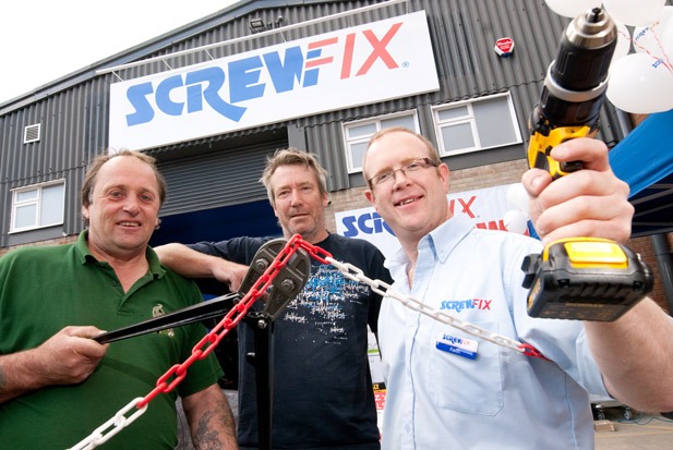 Local tradesman Richard Lawrence and Shaun Swales with store manager Keith Mawer cutting the chains of the new store