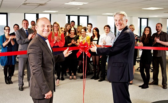 A cut above: Andrew Jones MP (right) officially opens NCI’s new customer services facility under the watchful eye of NCI’s Neil Richards-Smith (left) and the team A cut above: Andrew Jones MP (right) officially opens NCI’s new customer services facility under the watchful eye of NCI’s Neil Richards-Smith (left) and the team.