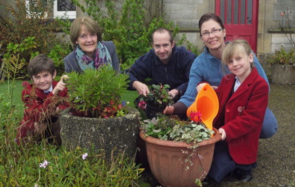 Rowan LaBonte, 7, Joy Allan, Chairman of the Trustees of Horticap, James McMaster, Horticap student, Kellie LaBonte, on the PTA committee and Nina Brooksbank, 8, planting colourful planters at Belmont Grosvenor School