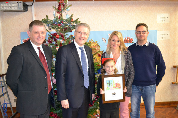 Andrew Jones MP with Maisie Jackson and her parents, holding a framed copy of her design