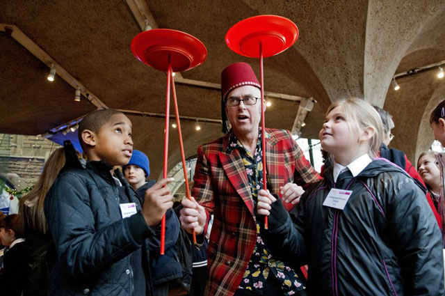 Students from Collingwood Primary School, Hull try plate spinning with Pete White and his suitcase circus