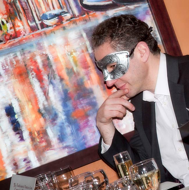 A customer enjoying Sasso Restaurant’s Venetian-themed Carnevale