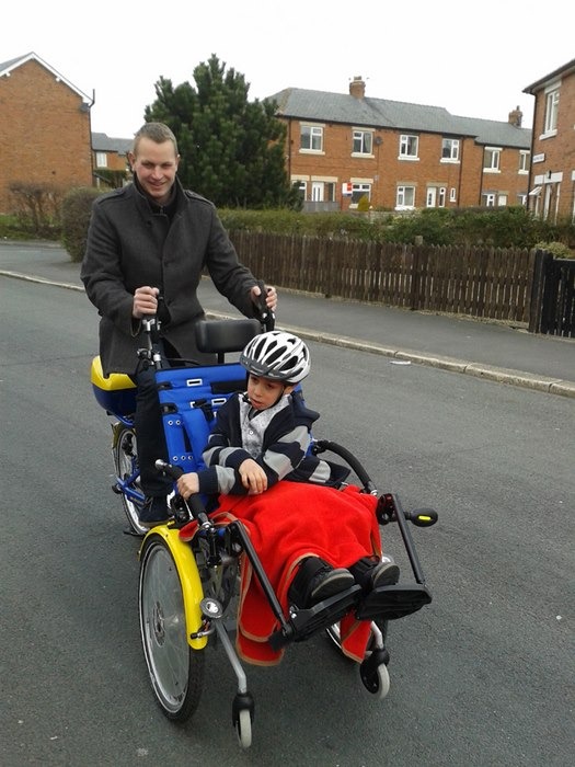 Yorkshire Young Achievers Foundation Trustee Nick Lawson takes Doroteo Ronda Perez for a test ride in his new tandem wheelchair bike