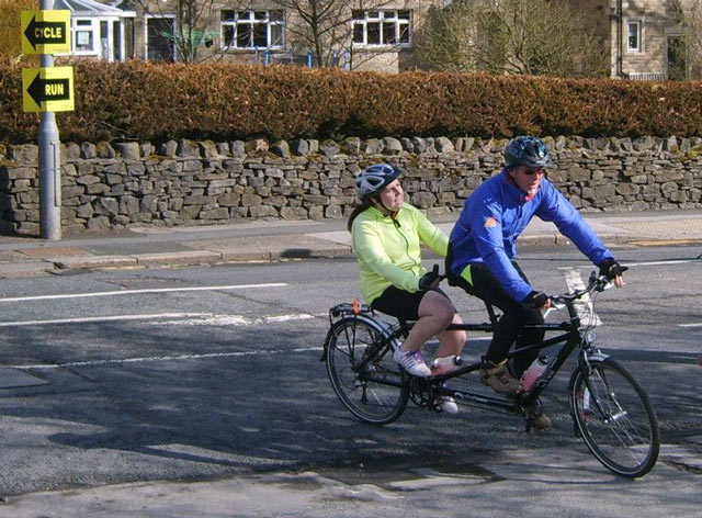 Shelley completes her 20 km tandem cycle, with volunteer Laurie