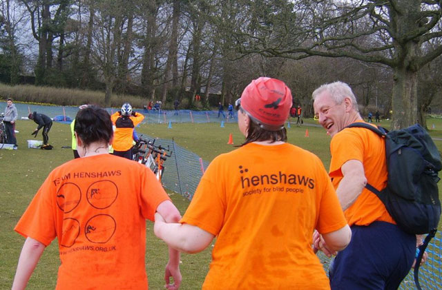 Tracey on her way to the transition area to change over with the cyclists, supported by Tessa and Alastair Tracey on her way to the transition area to change over with the cyclists, supported by Tessa and Alastair