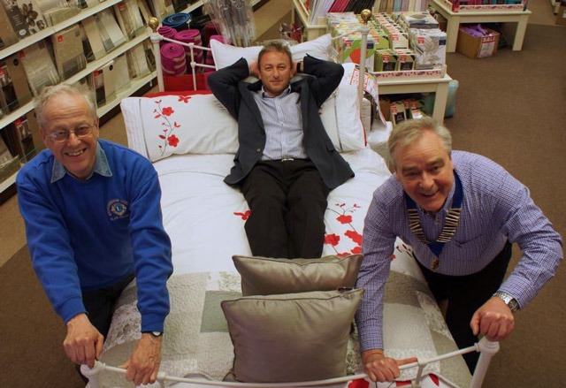 Beds Flying Out Of The Door! Alan Walgate (left) and Nigel Perry (right) from the Knaresborough Lions showing new sponsor, The Yorkshire Linen Co’s Ross Leventhal, how bed racing is done!