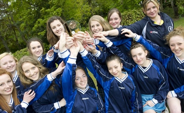 Saint John Fisher Catholic High School Girls Under 16 Football get their hands on the Cup Final Trophy.