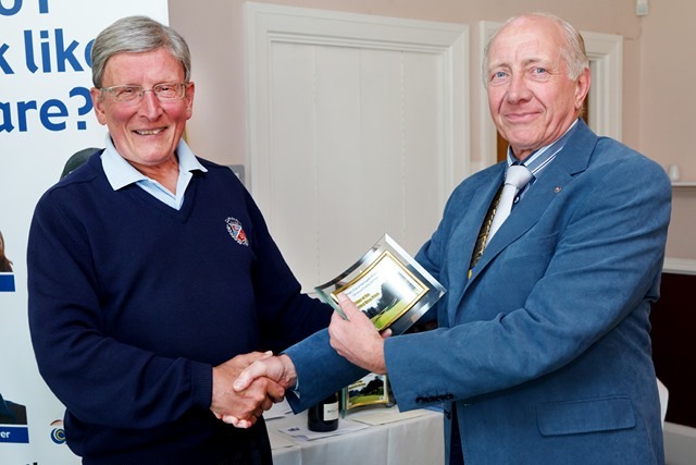 Alisdair Stewart receives his “nearest the middle” prize from Club President Mike Hammond