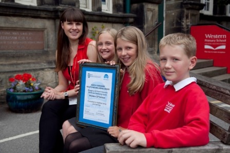 Miss Richardson and pupils display the North Yorkshire Health & Wellbeing Award