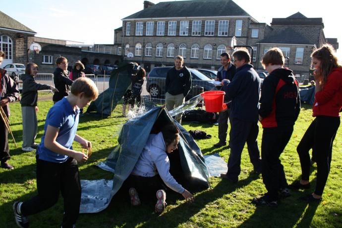 Year 9 students doing the Risky World challenge – testing their shelters are weatherproof