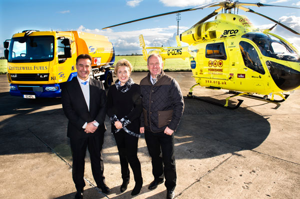 GOING PLACES: Pictured (L to R) in front of a Kettlewell Fuels tanker with the new Jet livery and a Yorkshire Air Ambulance. Which is benefitting from the company’s 25th anniversary fund-raising effort, are Jet Fuels territory manager, Carl Smaller,  Kettlewell Fuels operations manager, Janet Kettlewell and her, husband, Trevor, a director.