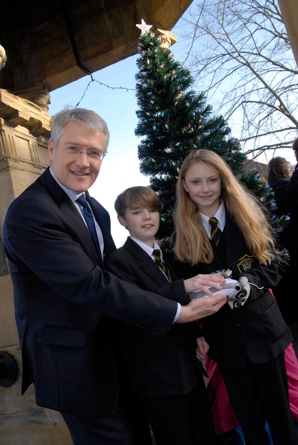 Andrew Jones, MP, switches on a fibre optic Christmas tree withJosh Blakeley (12) and Ellon Williams (11) both from Boroughbridge High School