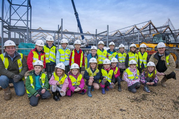 Site manager Steve Dwan, left, and Contracts manager Andrew Schofield with some of the visiting youngsters from Oatlands Infants School