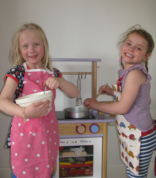 Local children, Clara and Daisy (L-R) practise their baking skills for ‘The Great British Bake-Off’ at the Oatlands Community Gala Fun Day.