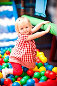 A-little-girl-plays-in-the-ball-pit-at-Wacky-Warehouse