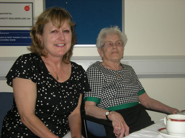 (L_R) Volunteer visitor Nicky Horsman and Carers’ Time Off client, Val Hussey, enjoying afternoon tea during at the Carers’ Time Off tea party