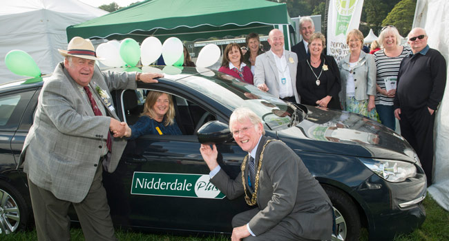 County Councillor John Fort, president of the Nidderdale Show, hands over the keys to the county council’s first community car to Katy Penn, Nidderdale Plus partnership manager, with county council chairman Tim Swales
