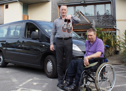 Marathon Runner Wanted! Disability Action Yorkshire Care Home Manager Steven Taylor with resident Wayne Martin in front of the existing “bus”
