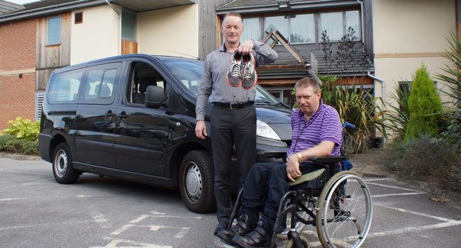 Marathon Runner Wanted! Disability Action Yorkshire Care Home Manager Steven Taylor with resident Wayne Martin in front of the existing “bus”