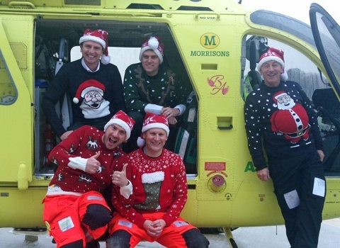 Ho! Ho! Ho! Ready to recycle those Christmas jumpers are (sat inside) Yorkshire Air Ambulance Paramedics Pete Vallance and Matt Syrat, (sat on step) Al Day & Graham Pemberton and (standing) Pilot Captain Andy Hall