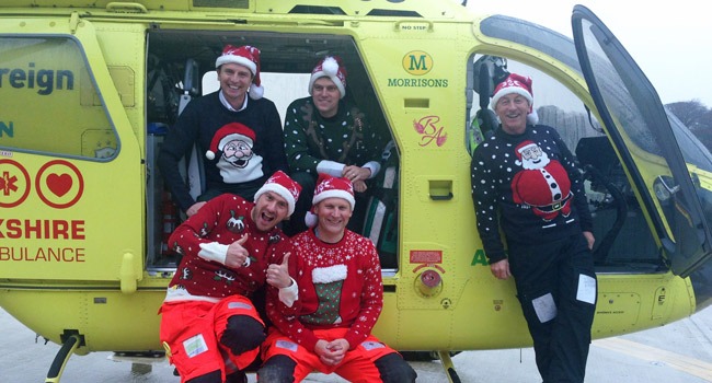 Ho! Ho! Ho! Ready to recycle those Christmas jumpers are (sat inside) Yorkshire Air Ambulance Paramedics Pete Vallance and Matt Syrat, (sat on step) Al Day & Graham Pemberton and (standing) Pilot Captain Andy Hall