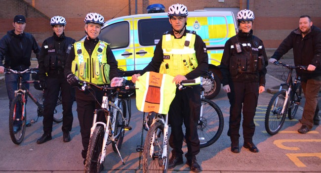 North Yorkshire Police’s Cycle Response Team and Sgt Ray Milligan and PC Linsey Moore with the cycle lights and reflective back pack covers