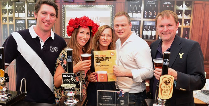 Actress Gaynor Faye presents 2014 winners, The Woolly Sheep Inn, with their award