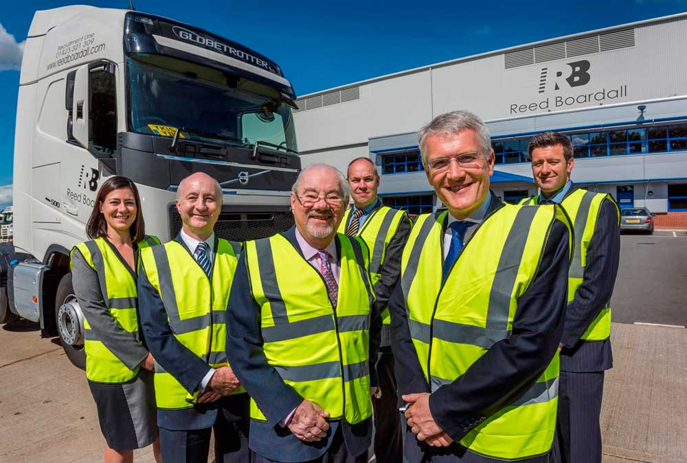 Sarah Roberts, finance director; Marcus Boardall, deputy chief executive; Keith Boardall, group chief executive; Andrew Baldwin, managing director of the cold storage division (behind); Andrew Jones MP and Howard Gill, managing director of the transport division
